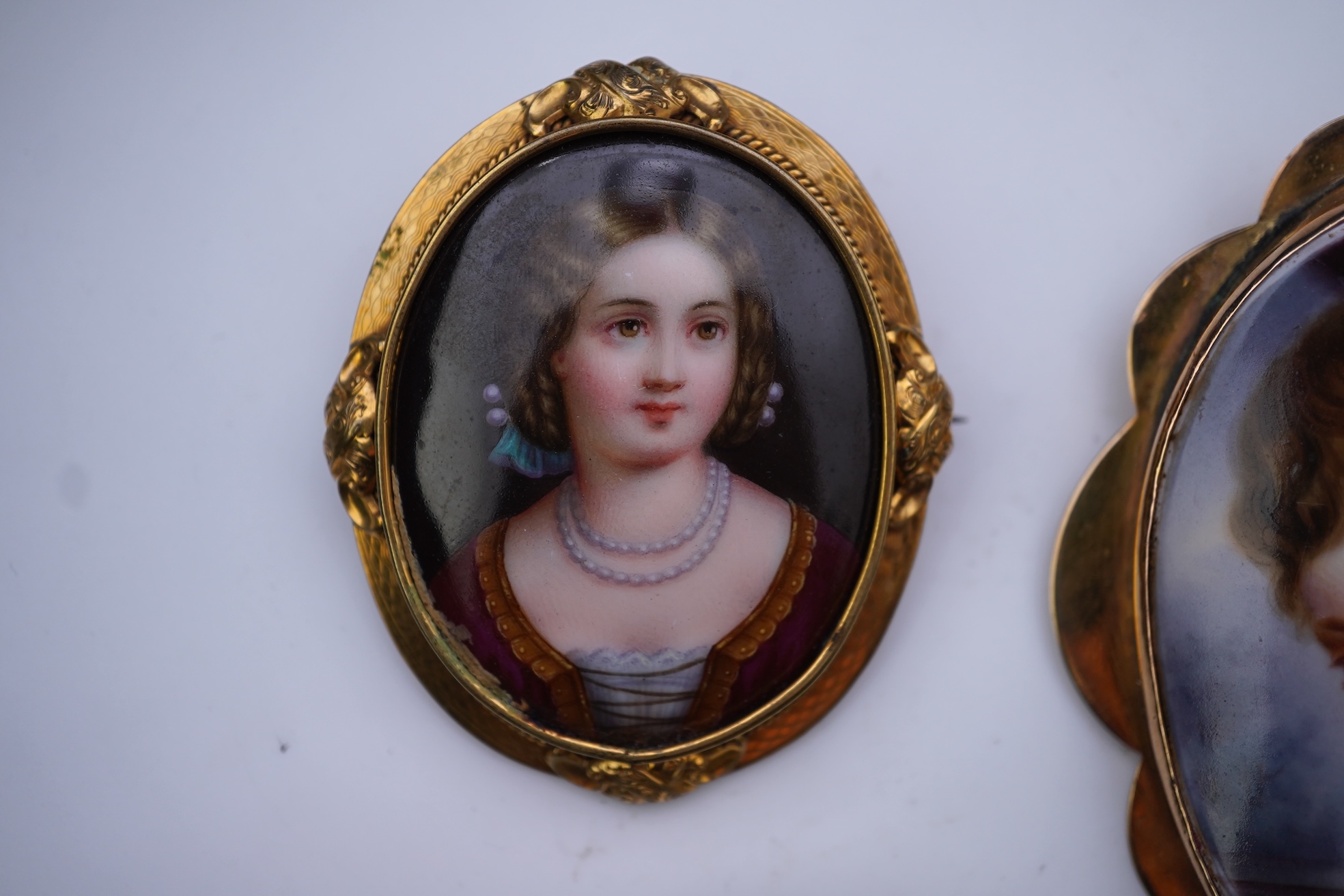 Three painted enamel brooches, mid 19th century